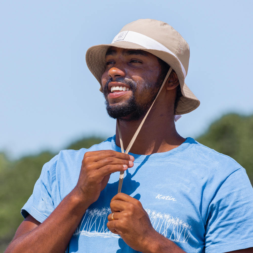 Professional Surfer wearing quick-dry surf hat during beach day